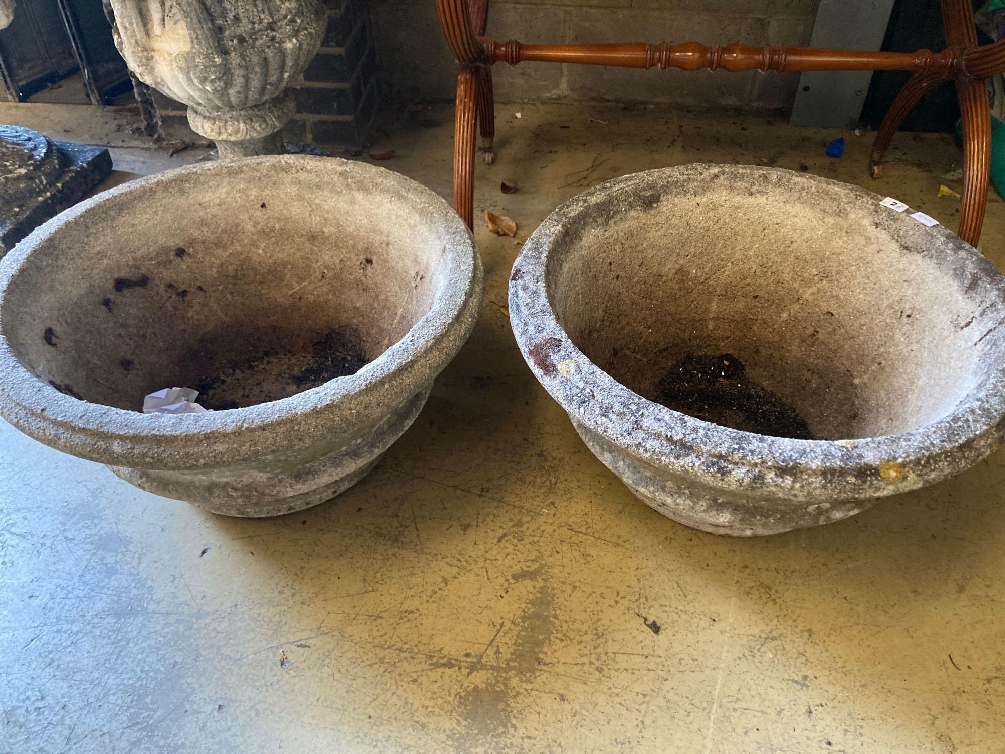 A pair of reconstituted stone garden urns, diameter 60cm height 31cm
